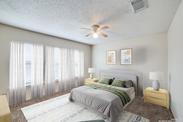 carpeted bedroom featuring ceiling fan, visible vents, and a textured ceiling