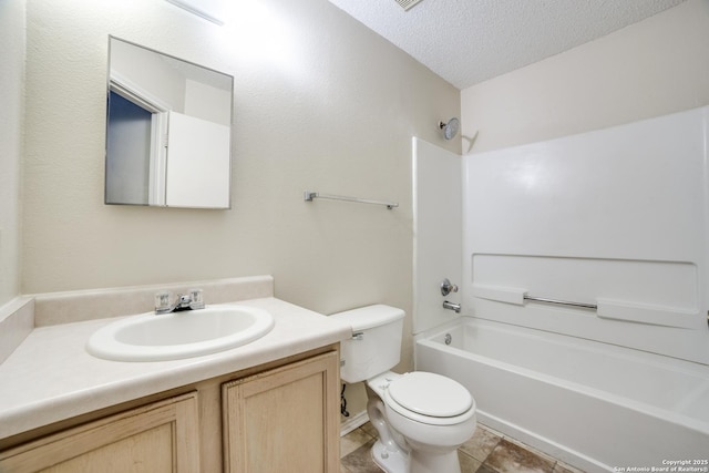 bathroom featuring a textured ceiling, shower / bathtub combination, vanity, and toilet