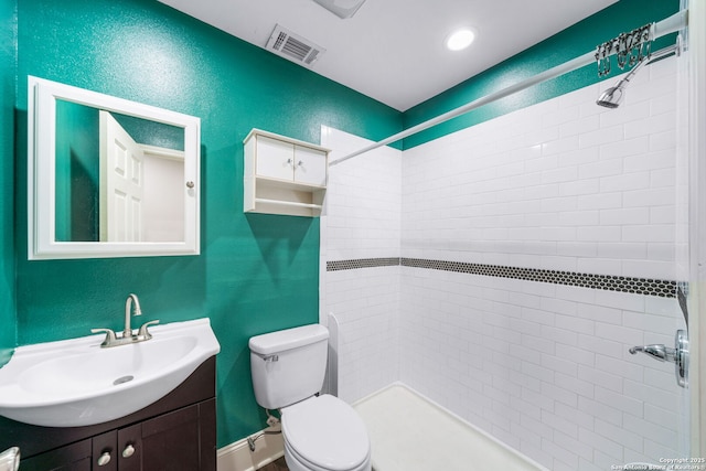 full bathroom with a textured wall, toilet, vanity, visible vents, and a stall shower