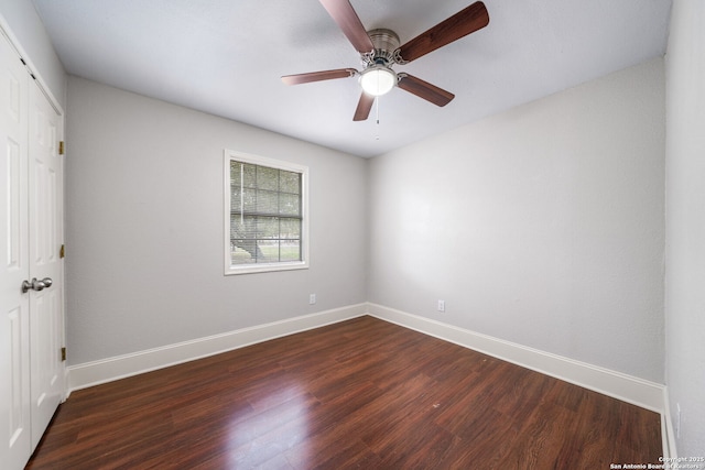 unfurnished room featuring dark wood-style floors, ceiling fan, and baseboards