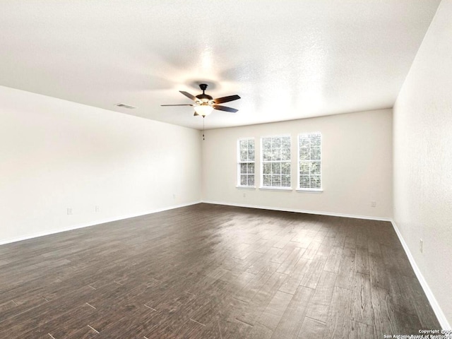 unfurnished room with dark wood-style floors, a textured ceiling, visible vents, and a ceiling fan