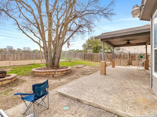 view of yard with a patio area, a fenced backyard, and a ceiling fan