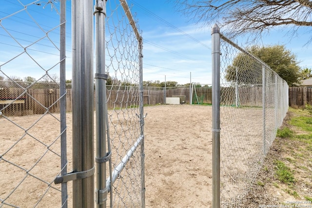 view of home's community featuring fence