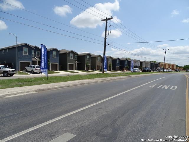 view of road with sidewalks, a residential view, and curbs