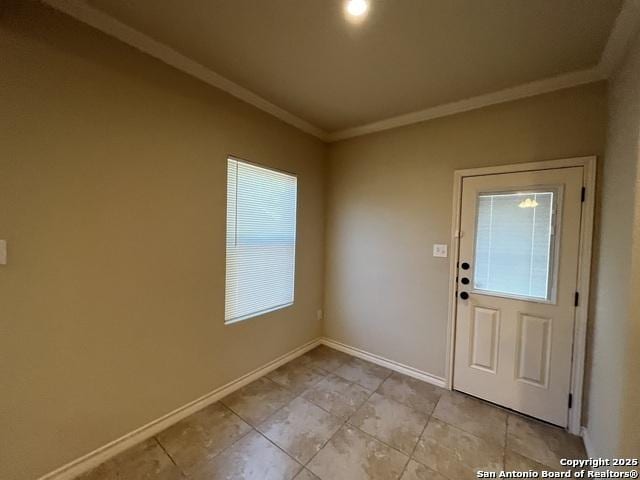 foyer entrance featuring baseboards, light tile patterned flooring, and crown molding