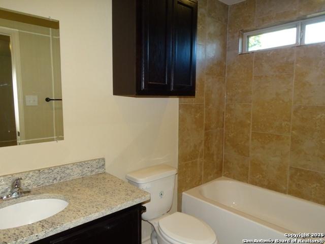 full bathroom with shower / bathing tub combination, vanity, and toilet