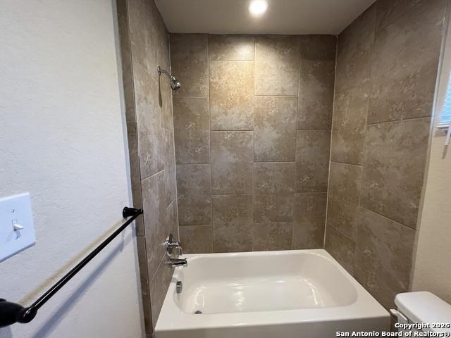 full bath featuring shower / washtub combination and toilet