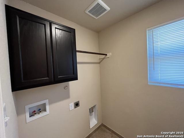 laundry room featuring hookup for a washing machine, cabinet space, visible vents, and electric dryer hookup