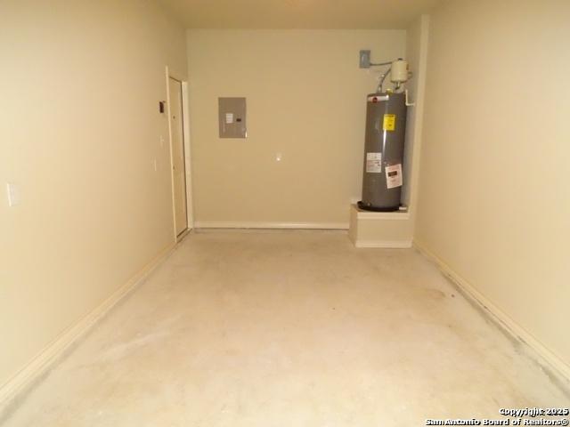 garage with water heater, electric panel, and baseboards