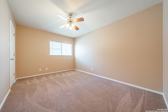 empty room featuring a ceiling fan, light carpet, and baseboards