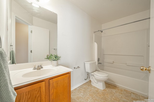 bathroom with baseboards, vanity, toilet, and shower / bathtub combination