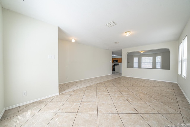 spare room featuring visible vents, baseboards, and light tile patterned flooring