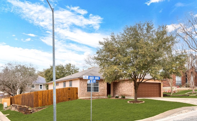 single story home featuring a garage, concrete driveway, fence, a front lawn, and brick siding