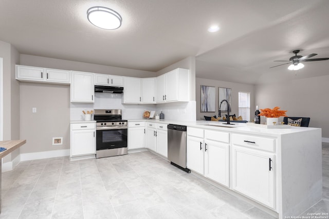 kitchen with light countertops, appliances with stainless steel finishes, white cabinetry, and under cabinet range hood