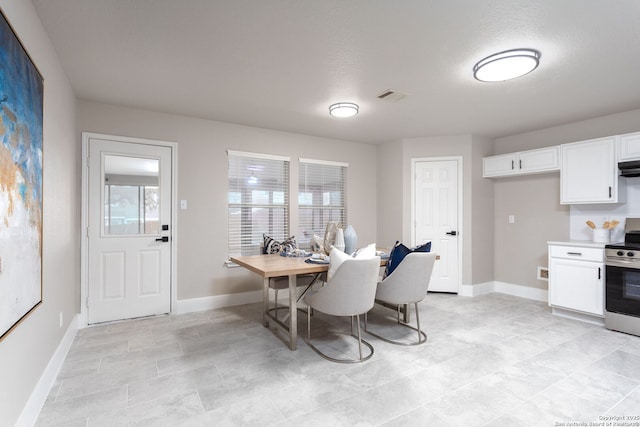 dining space featuring baseboards and visible vents