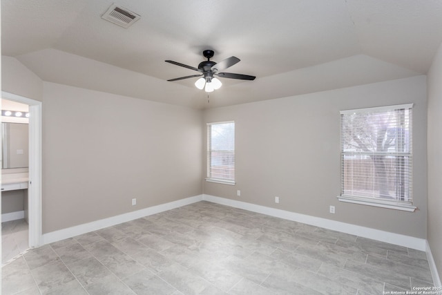 unfurnished room with visible vents, vaulted ceiling, baseboards, and ceiling fan