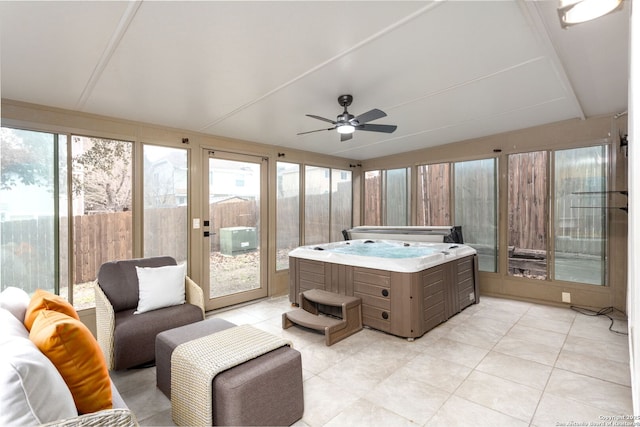 sunroom / solarium featuring ceiling fan