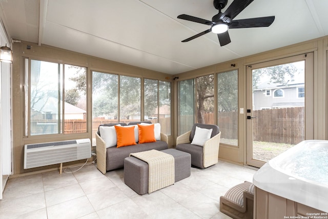 sunroom / solarium featuring an AC wall unit and a ceiling fan