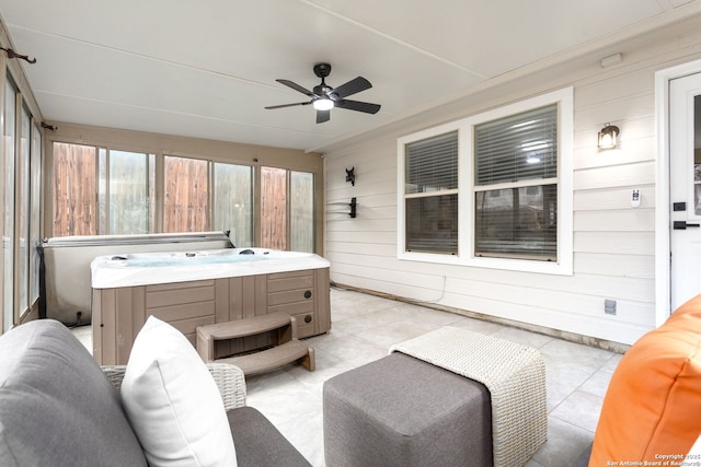 sunroom / solarium with a hot tub and a ceiling fan