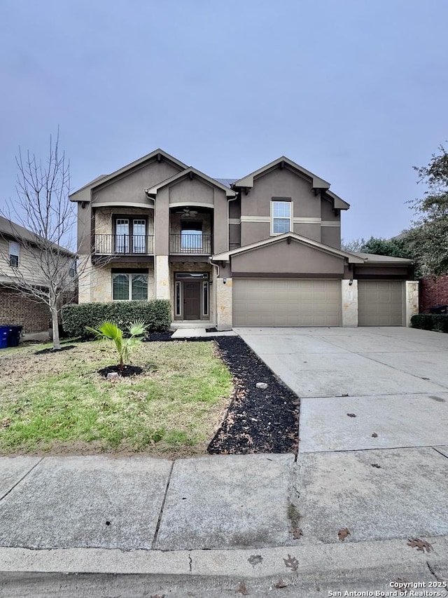 view of front of home with driveway, a balcony, and stucco siding