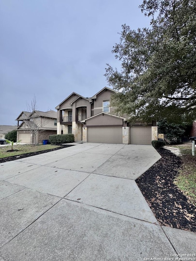 view of front of home with driveway, stone siding, and stucco siding