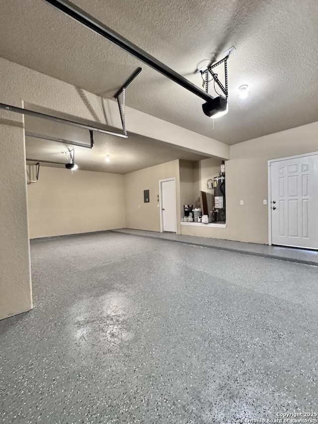 garage featuring water heater and a garage door opener