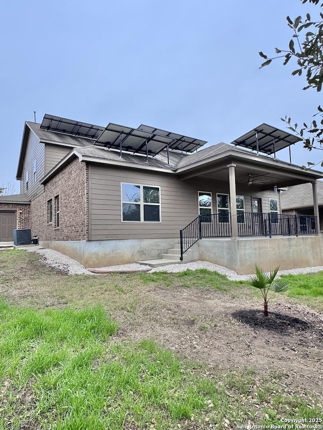 exterior space featuring cooling unit and brick siding