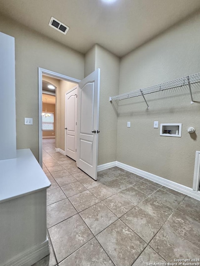 laundry room featuring tile patterned flooring, hookup for a washing machine, laundry area, visible vents, and baseboards