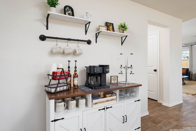 bar with dark wood-style floors and baseboards