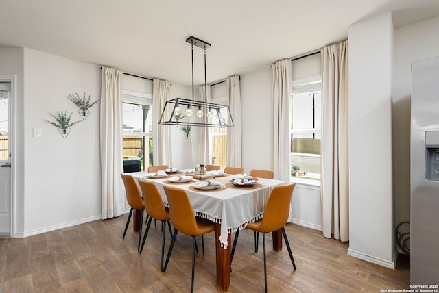 dining room featuring baseboards and wood finished floors