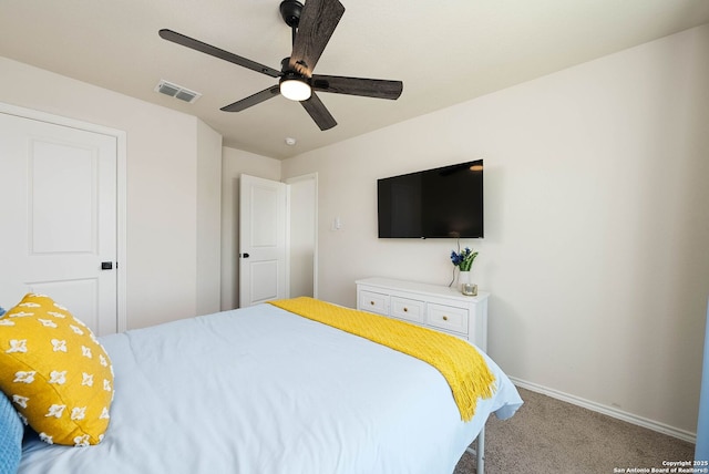 bedroom with a ceiling fan, carpet flooring, visible vents, and baseboards