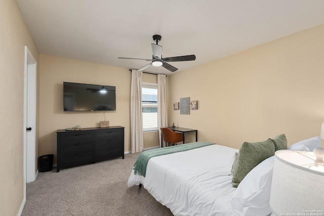 bedroom featuring baseboards, a ceiling fan, and light colored carpet