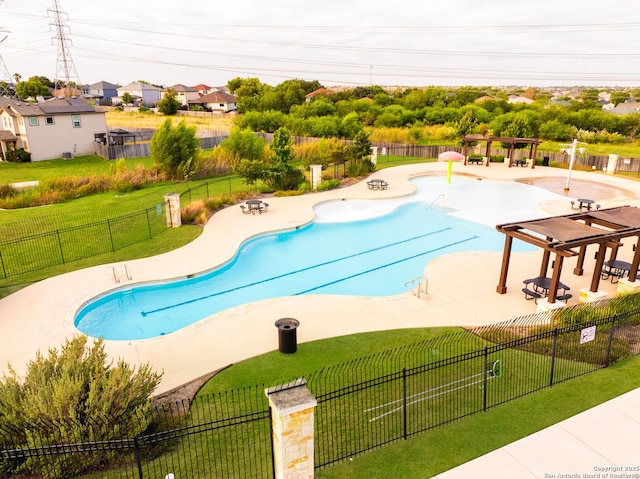 community pool featuring a yard, a patio, and fence