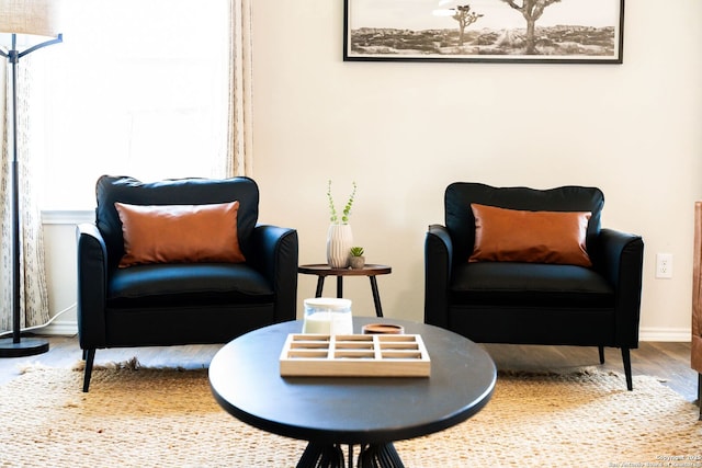 living area with wood finished floors and baseboards