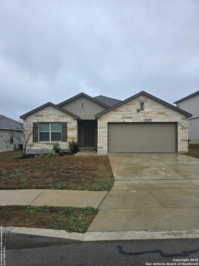 view of front of house with driveway, stone siding, and an attached garage