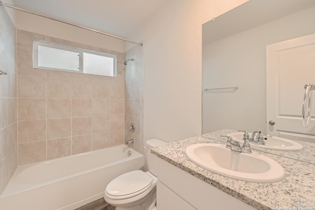 full bath featuring shower / bathing tub combination, vanity, and toilet