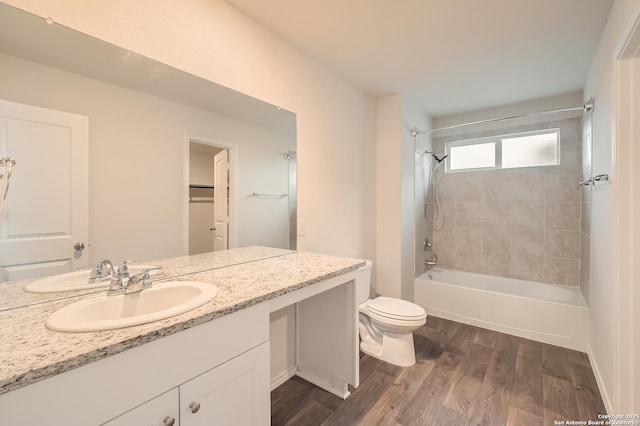 bathroom with vanity, tub / shower combination, wood finished floors, and toilet