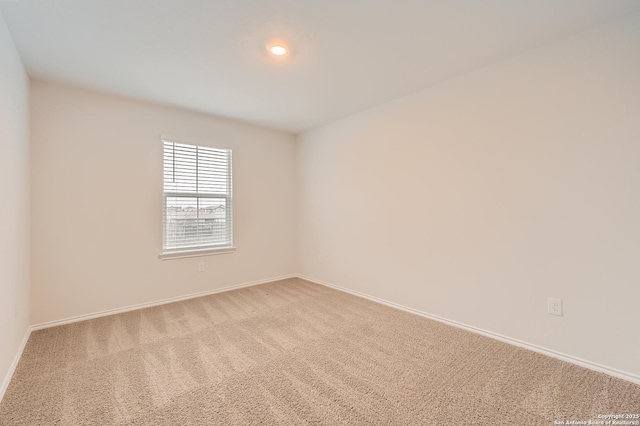 carpeted empty room with baseboards