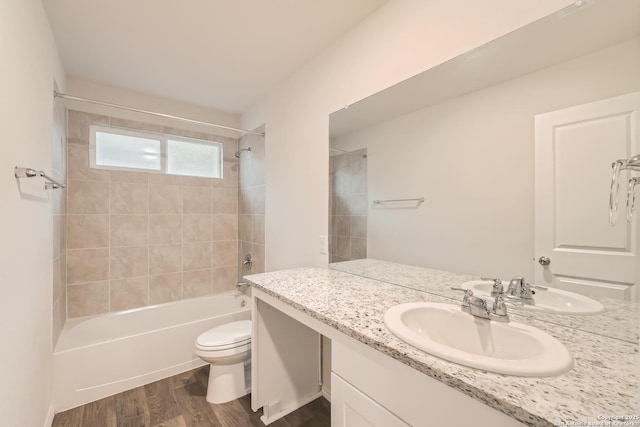 full bathroom with  shower combination, toilet, wood finished floors, and vanity