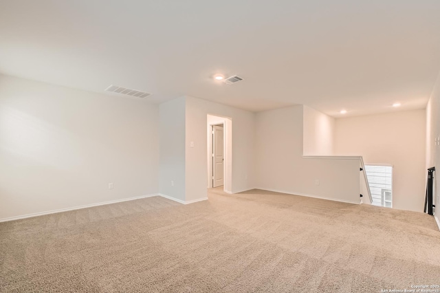 unfurnished room featuring baseboards, recessed lighting, visible vents, and light colored carpet