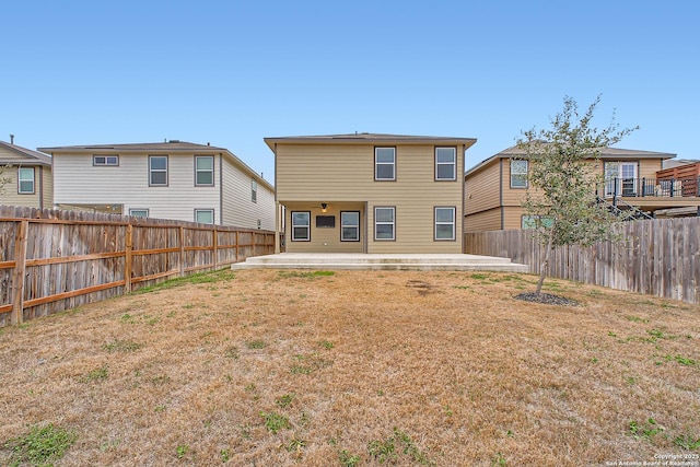 back of house featuring a patio area, a fenced backyard, a residential view, and a lawn