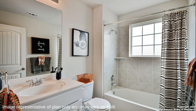 full bathroom featuring toilet, visible vents, shower / tub combo with curtain, and vanity