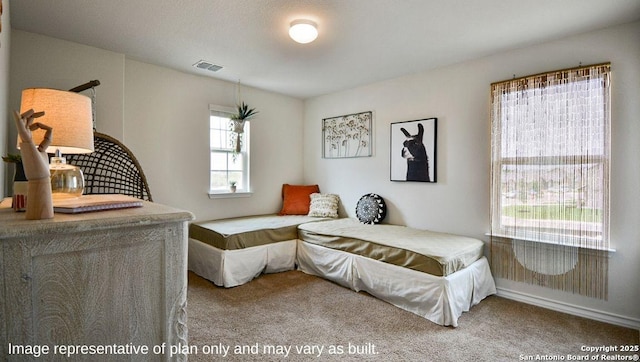 carpeted bedroom featuring baseboards and visible vents