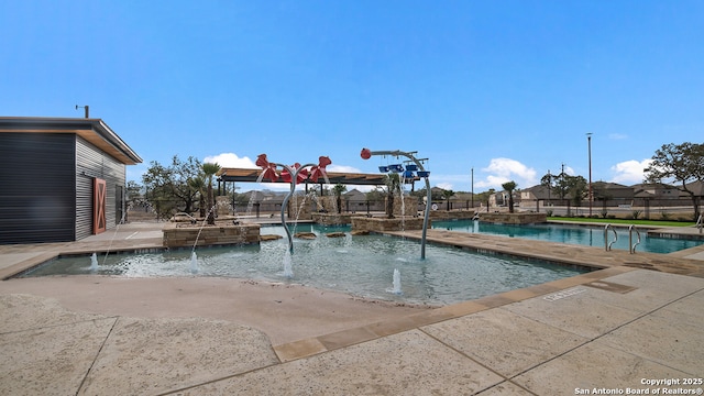 pool with a patio and fence