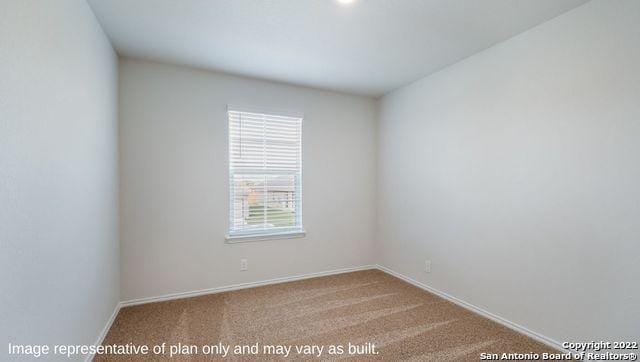 unfurnished room with carpet and baseboards