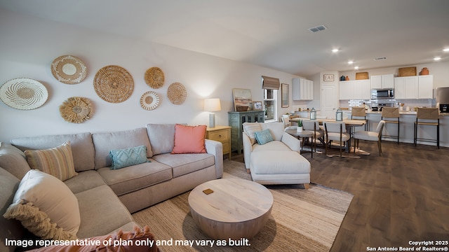 living area with lofted ceiling, visible vents, recessed lighting, and wood finished floors