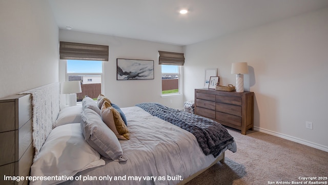 bedroom with light colored carpet, baseboards, and multiple windows