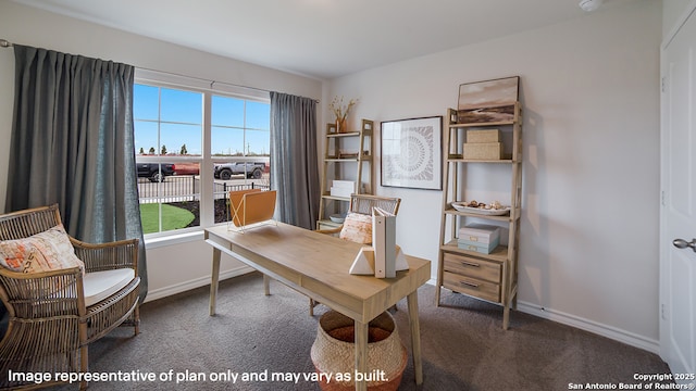 office space featuring baseboards and dark carpet