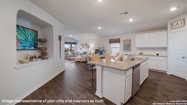 kitchen featuring a sink, visible vents, white cabinets, dishwasher, and a center island with sink