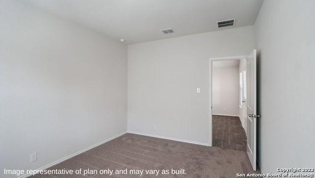 carpeted spare room with baseboards and visible vents